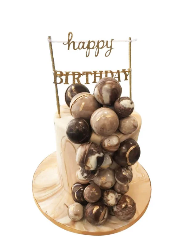 Chocolate celebration cake with a happy birthday topper