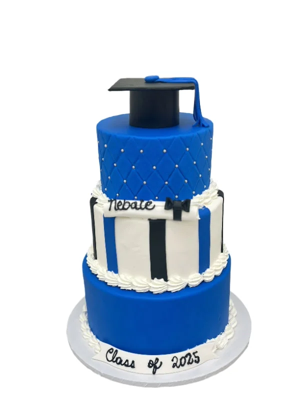 Blue and white graduation cake with a mortarboard