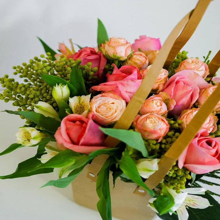 Pink roses arranged in a wooden basket